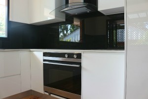 white kitchen with black glass                                        
